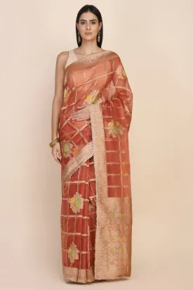 Beautiful rust orange color floral motif highlighted saree