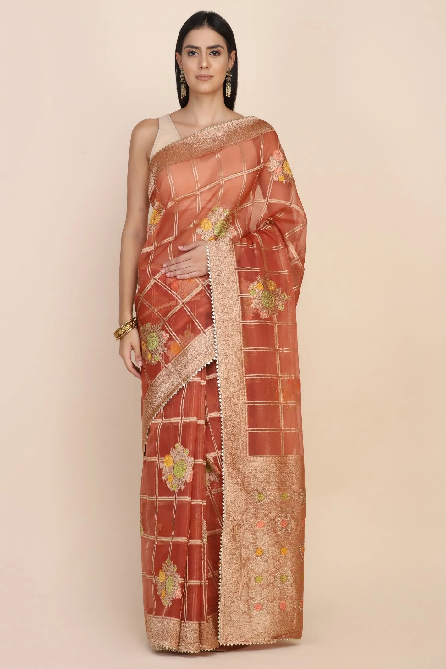 Beautiful rust orange color floral motif highlighted saree