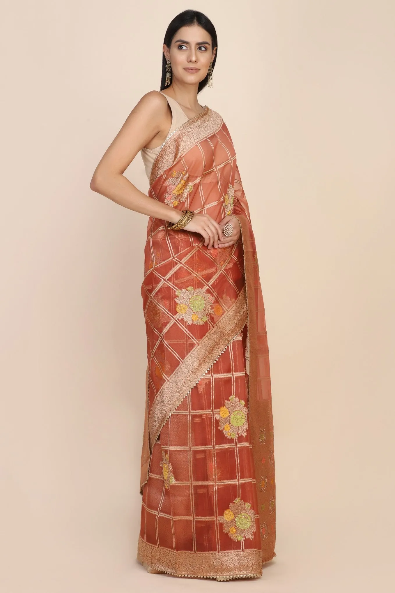Beautiful rust orange color floral motif highlighted saree