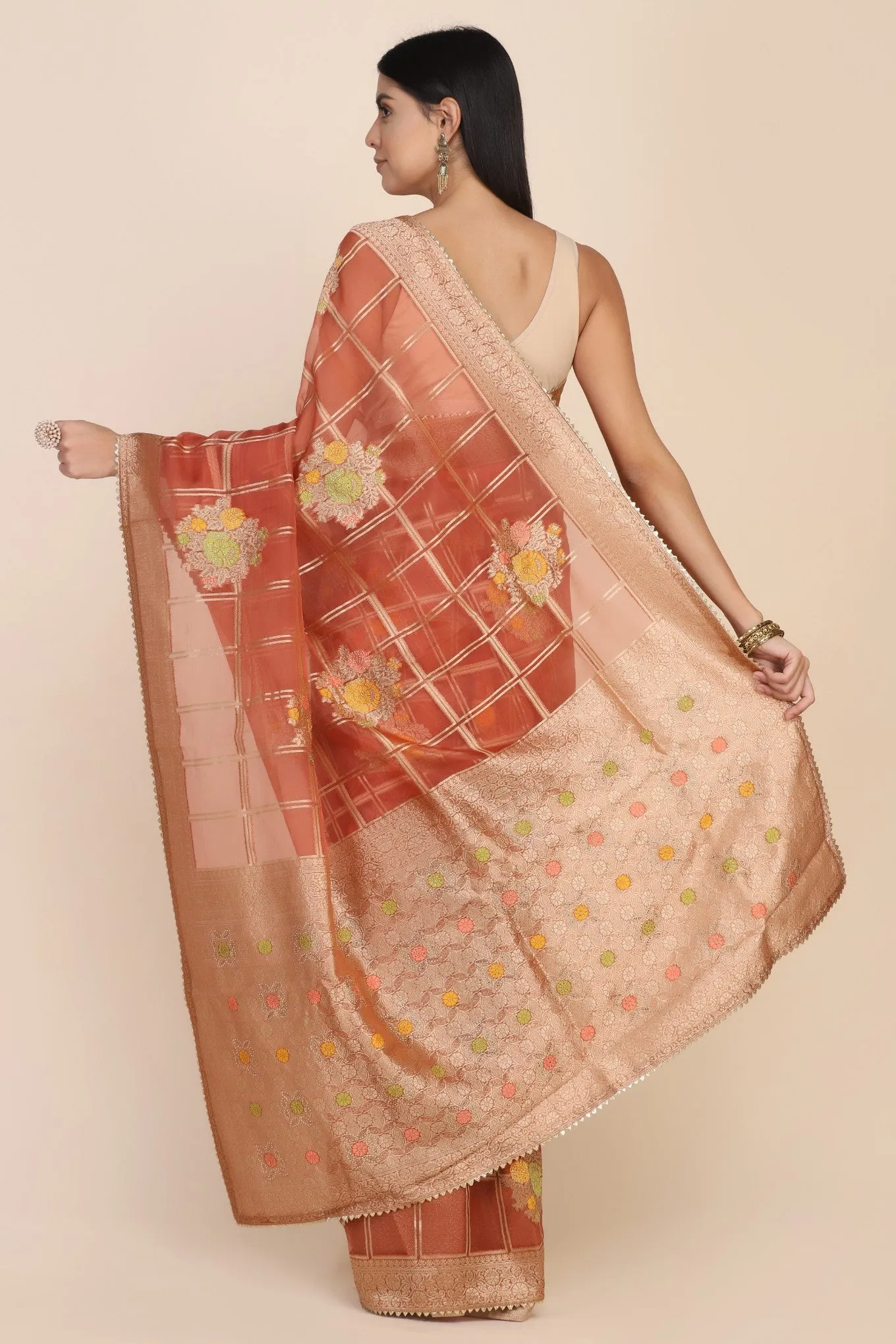 Beautiful rust orange color floral motif highlighted saree